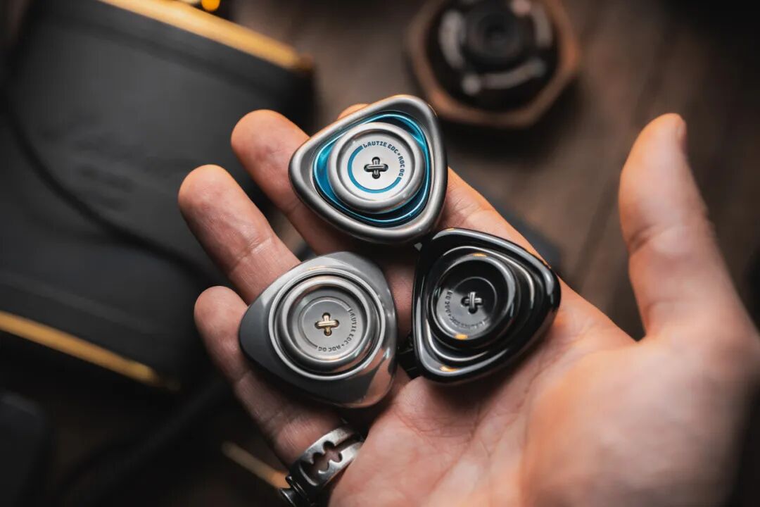 LAUTIE ROC OG three variants in palm stainless zirconium and titanium baked-blue side by side scale reference